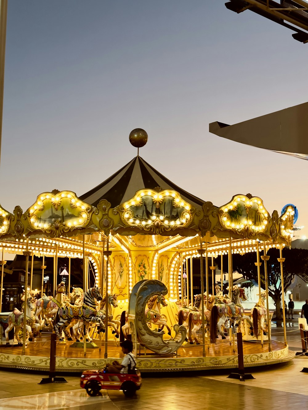 a merry go round with people riding on it