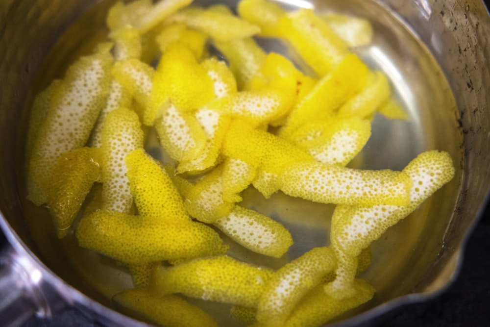a pan filled with yellow starfish sitting on top of a stove