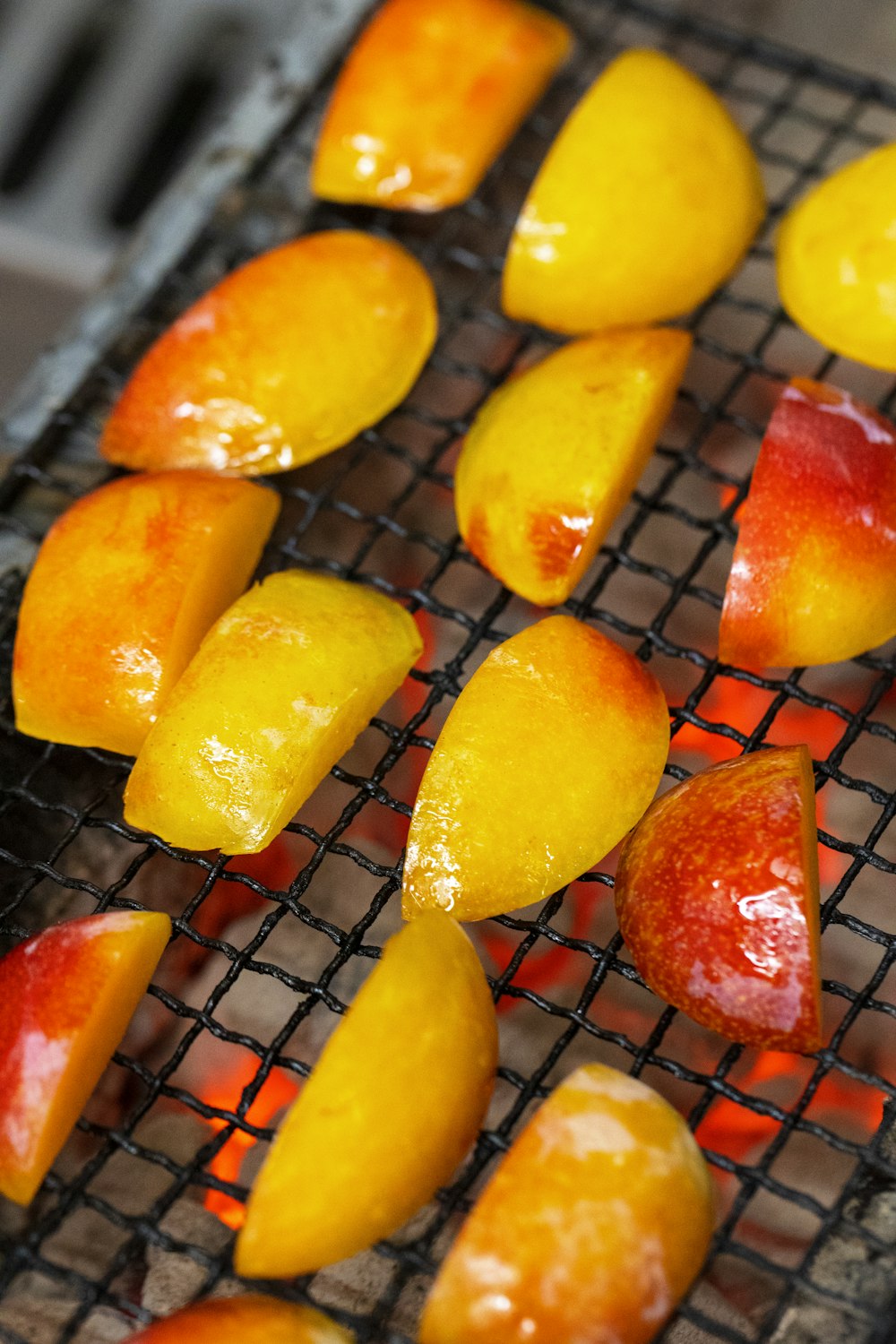 a bunch of fruit is cooking on a grill