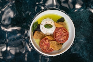 Artisanal burrata di bufala split open to reveal its soft, creamy center surrounded by a delicate cheese shell