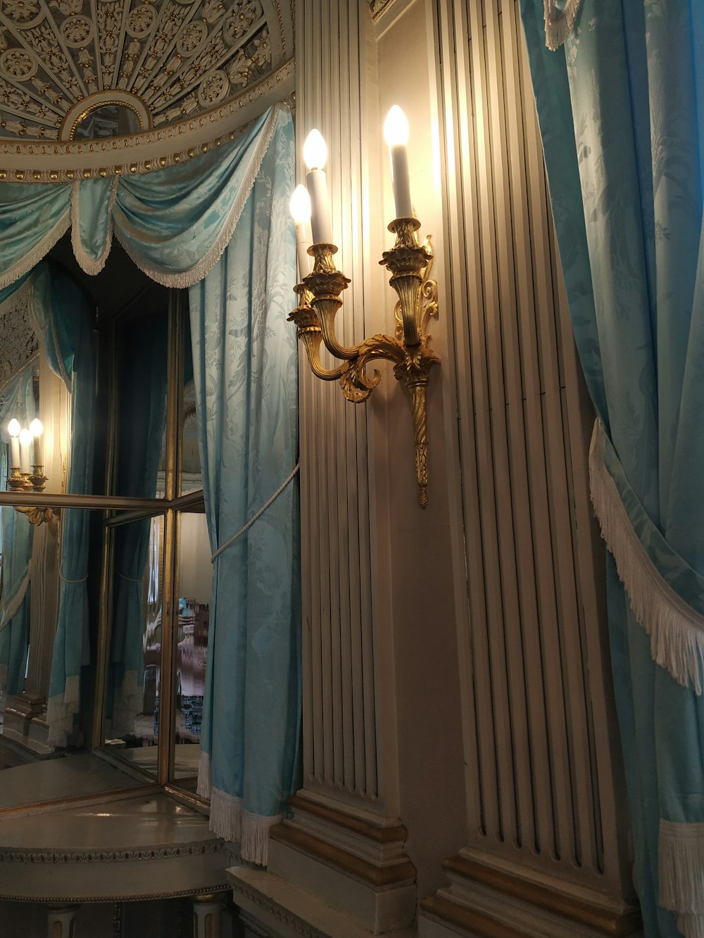 a fancy room with a chandelier and a mirror