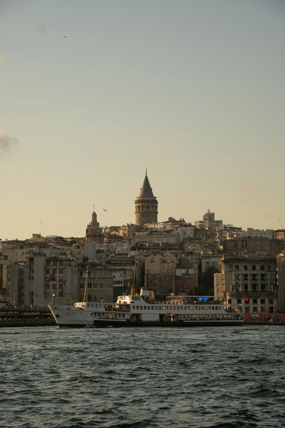 a large boat in the water near a city