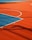 A vibrant sports court with sections of red and blue, featuring crisp white lines marking the boundaries. Shadows from a structure create geometric patterns across the surface, adding depth and interest to the scene.