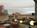 Rooftop chill zone featuring lounge chairs and city skyline views.