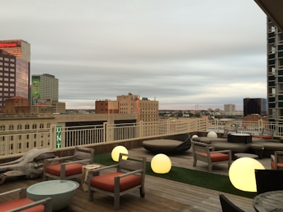Rooftop chill zone featuring lounge chairs and city skyline views.