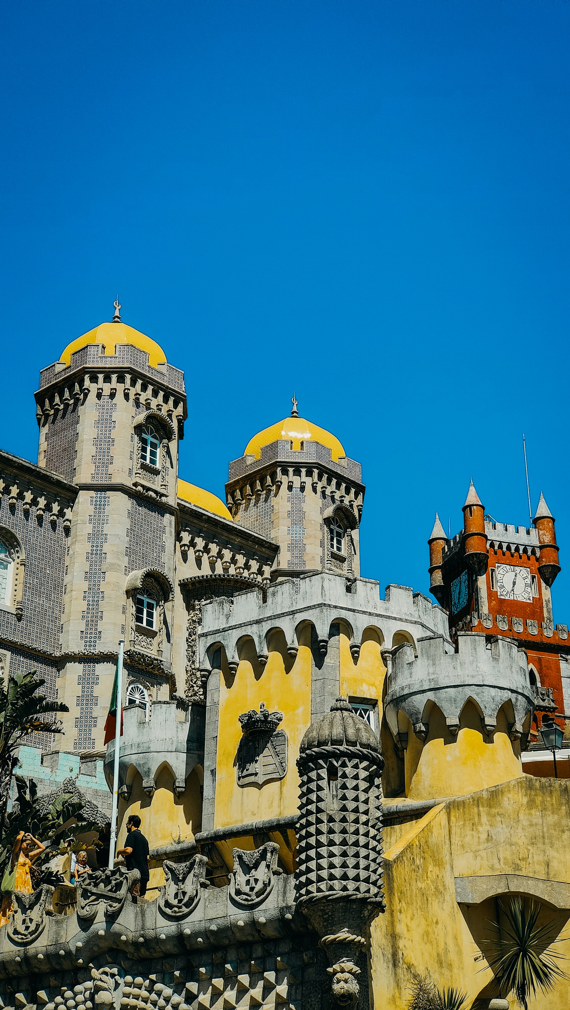 A castle like building with a clock on the front of it photo – Free ...
