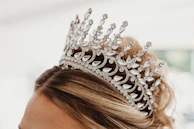 A close-up of a bridal updo adorned with delicate gold hair accessories.
