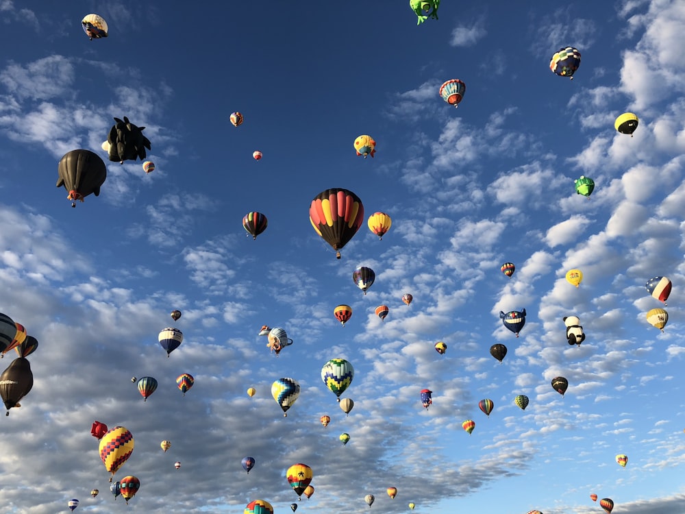 a bunch of hot air balloons flying in the sky