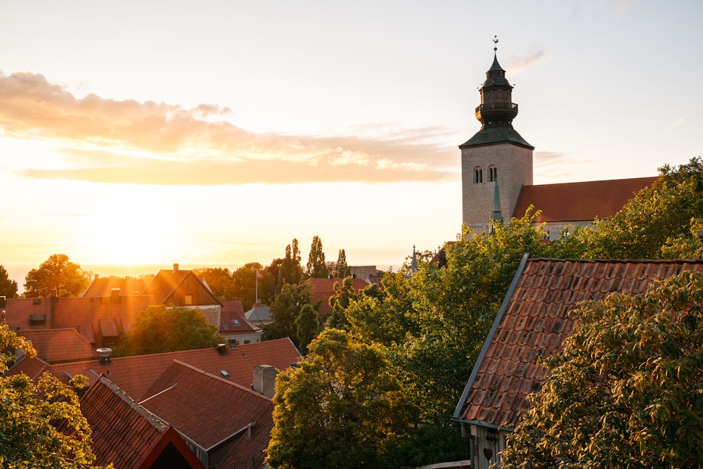 the sun is setting over a small town