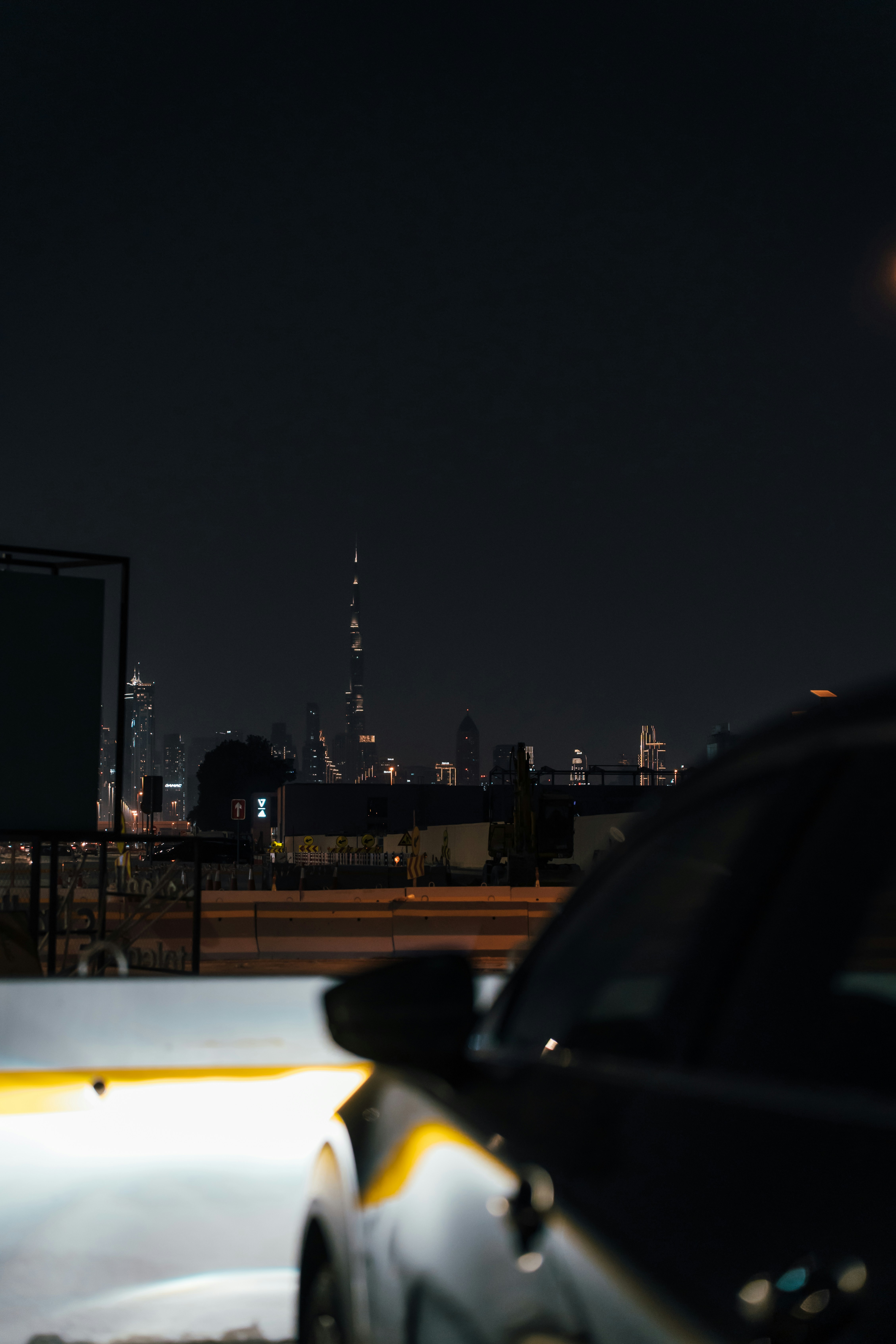 a car driving down a street at night