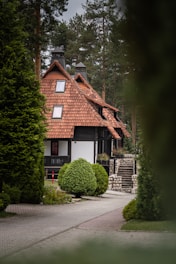 a house with a red roof surrounded by trees