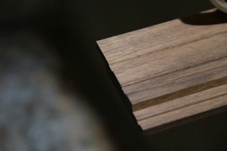 a close up of a watch on a wooden surface