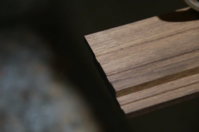 a close up of a watch on a wooden surface