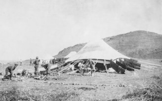 Medical camp setup with doctors attending to patients under a temporary tent.