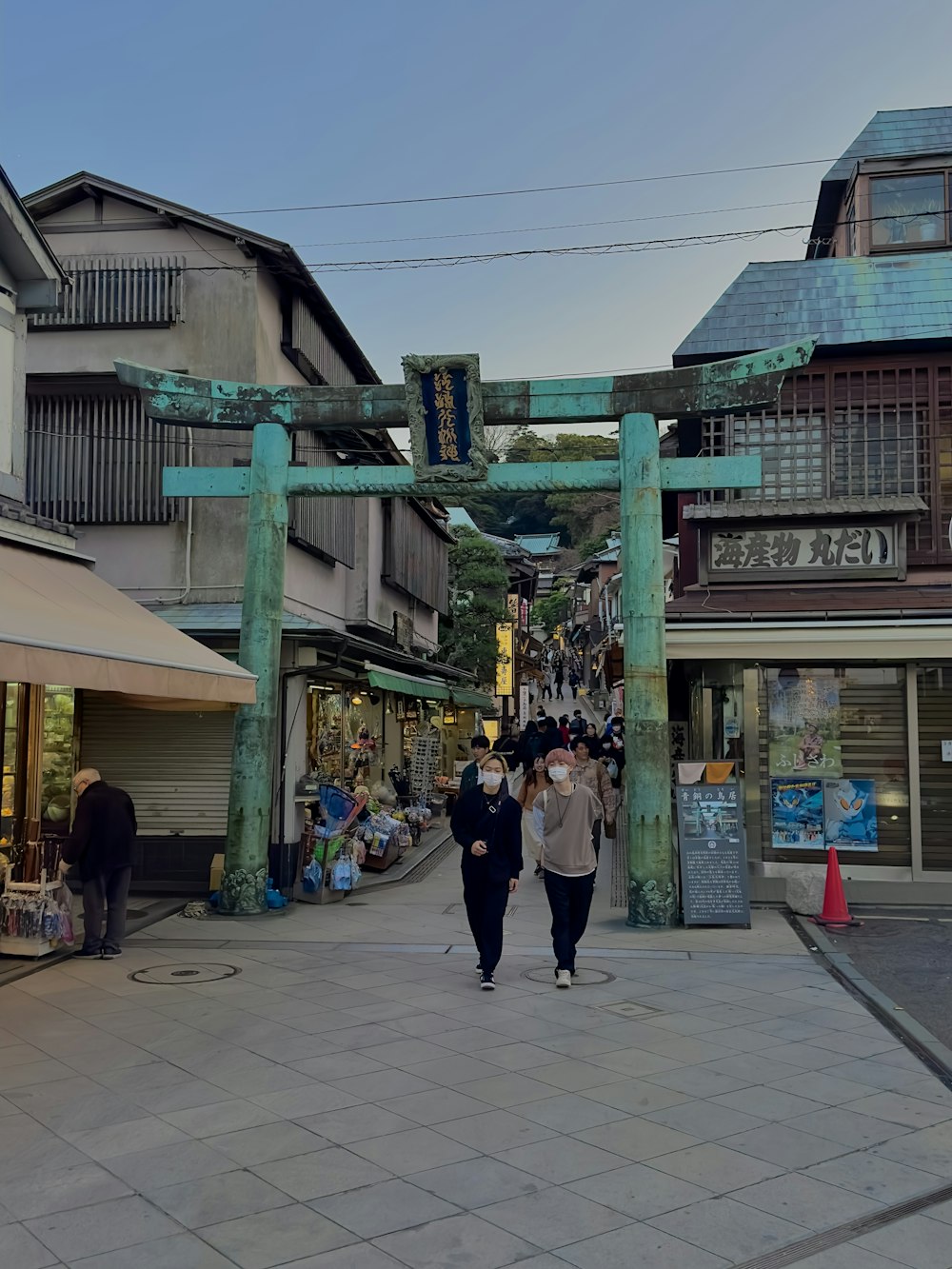 a couple of people that are walking down a street