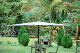 UV-resistant garden umbrella casting shade over a vibrant outdoor seating area.