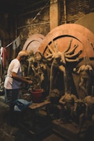 An artist’s workspace with digital sculpting tools and a miniature in progress on screen.