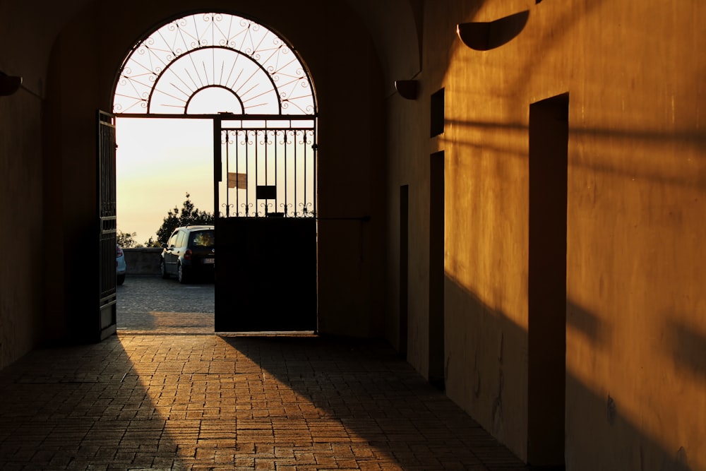 an open door leading to a parking lot with a ferris wheel in the background