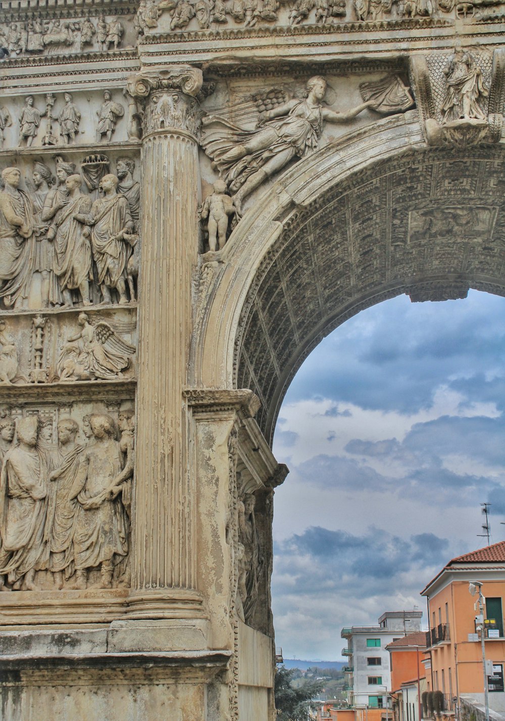 a stone arch with a clock on top of it