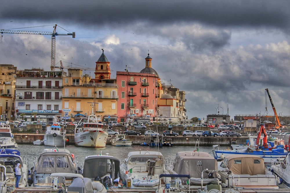 a harbor filled with lots of boats under a cloudy sky