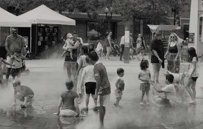 Families participating in a water safety workshop outdoors on a sunny day.