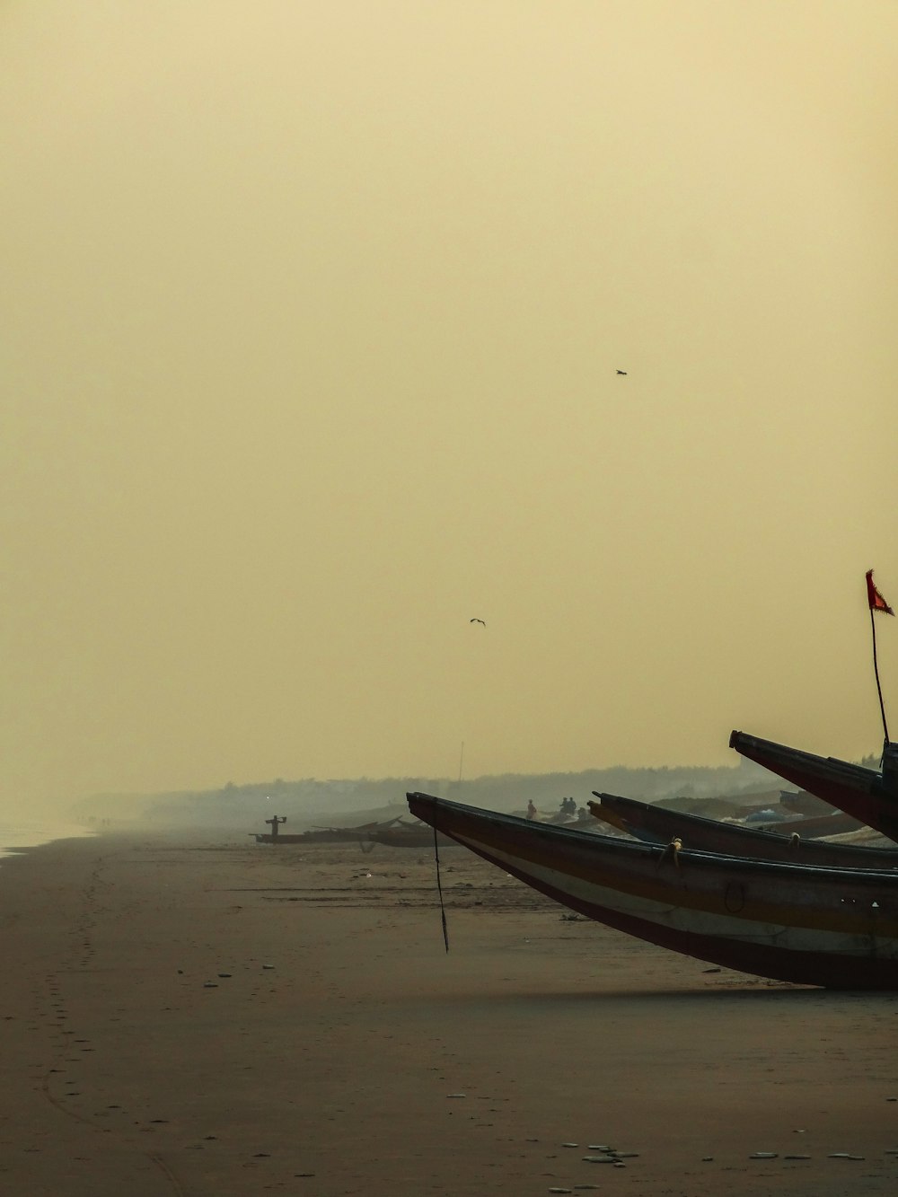 a couple of boats that are sitting in the sand