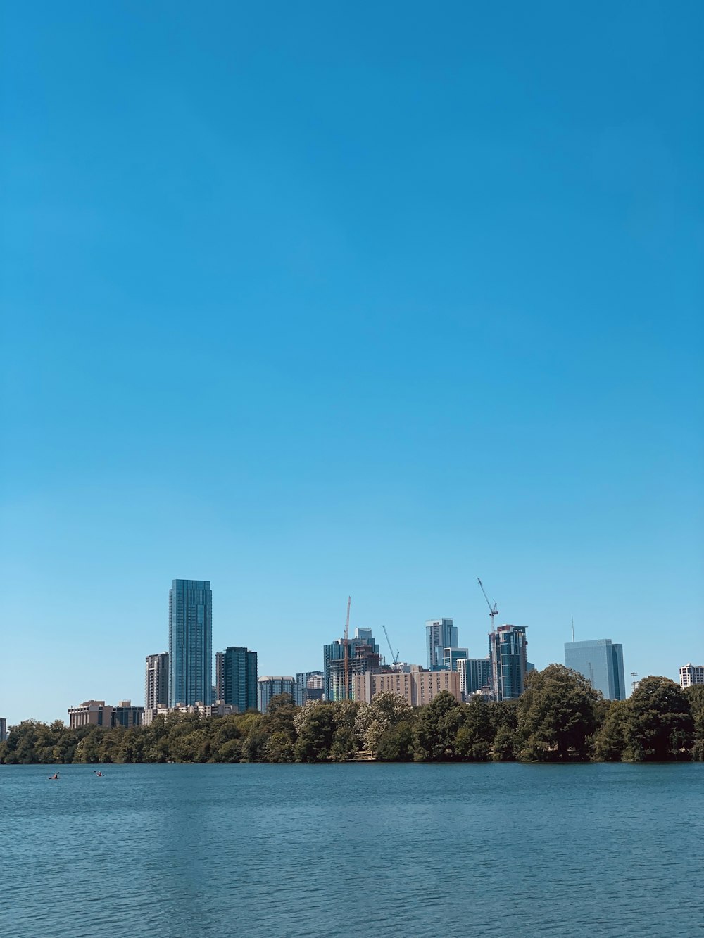 a large body of water with a city in the background