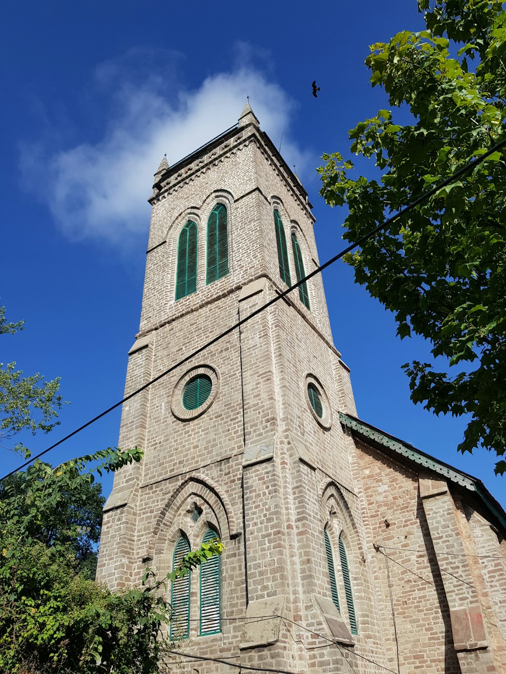 a tall brick tower with a clock on it's side