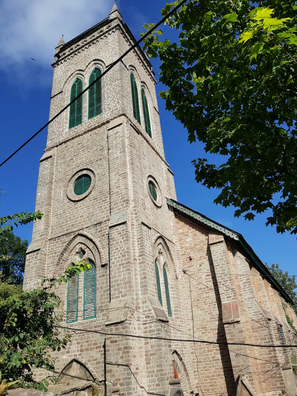 a tall brick building with a clock on it's side