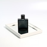 A stylish customer spritzing a bellevra fragrance in front of a minimalist mirror.