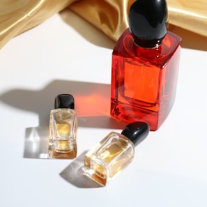 a bottle of perfume next to a small bottle of perfume
