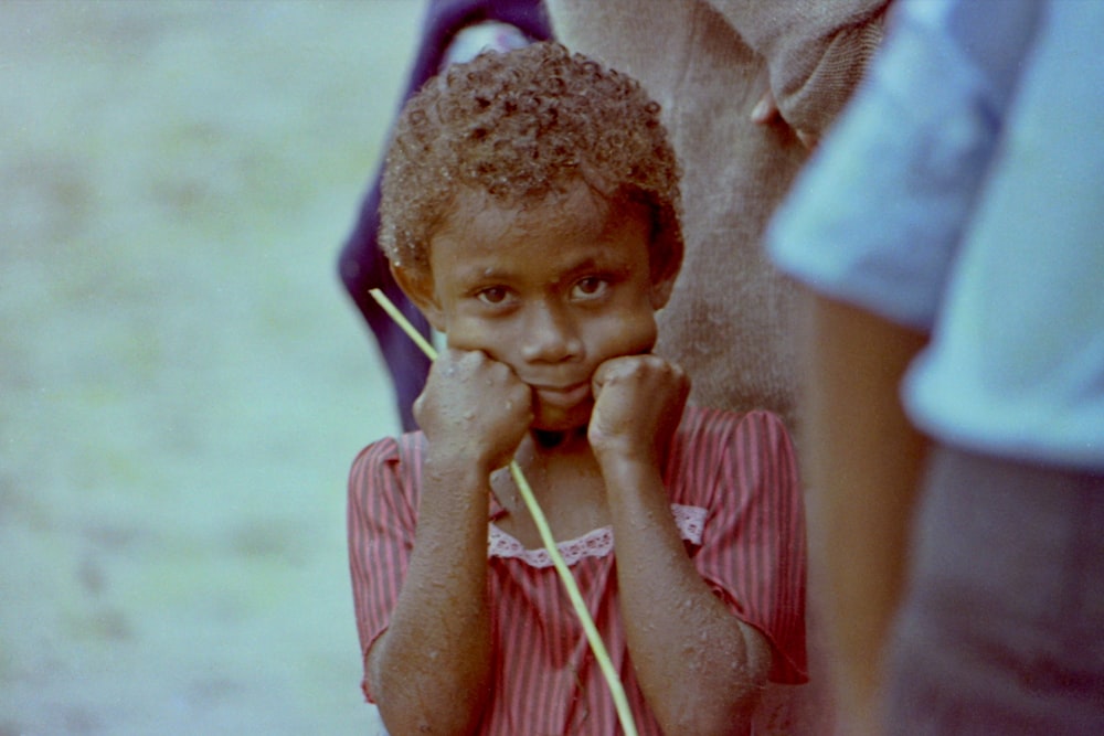 a little girl holding a pair of headphones to her ear