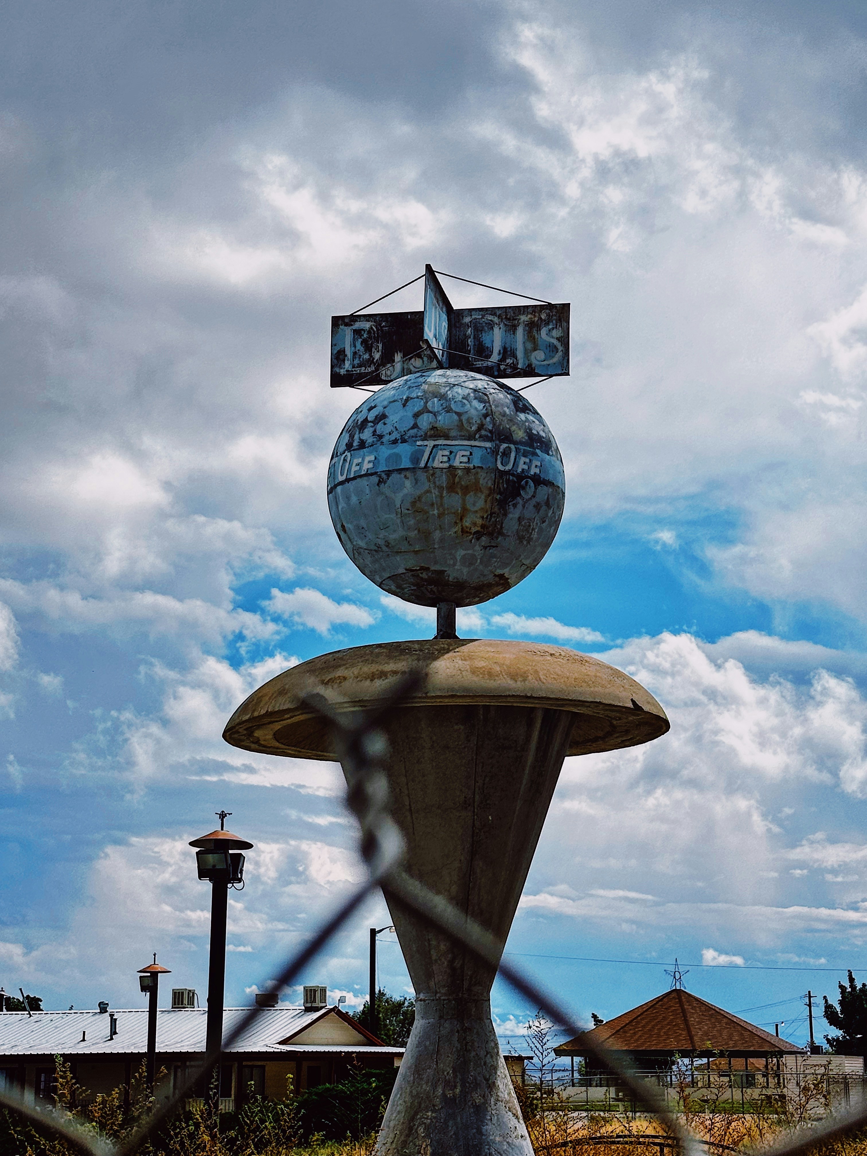 a metal sculpture with a globe on top of it