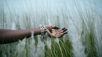 A serene scene of a person wearing the fragrance bracelet while meditating in a peaceful natural setting