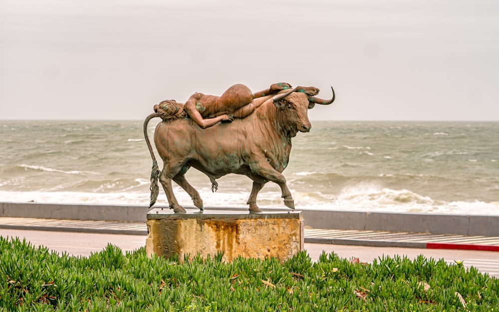 eine Statue einer Frau, die auf einem Stier liegt