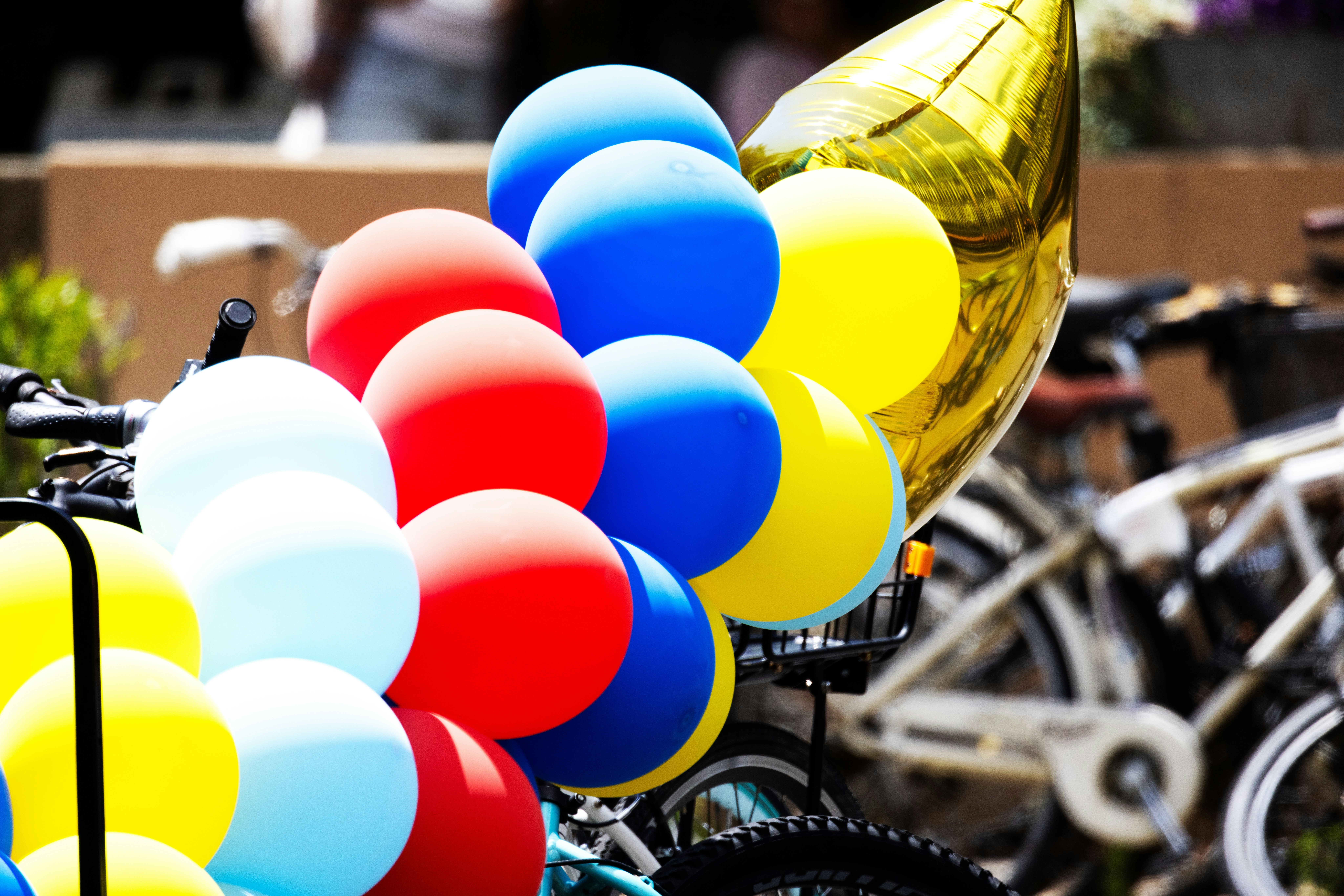 a bunch of balloons that are on a bike