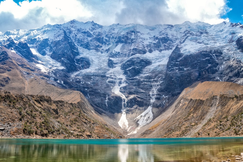 a mountain range with a lake in the foreground