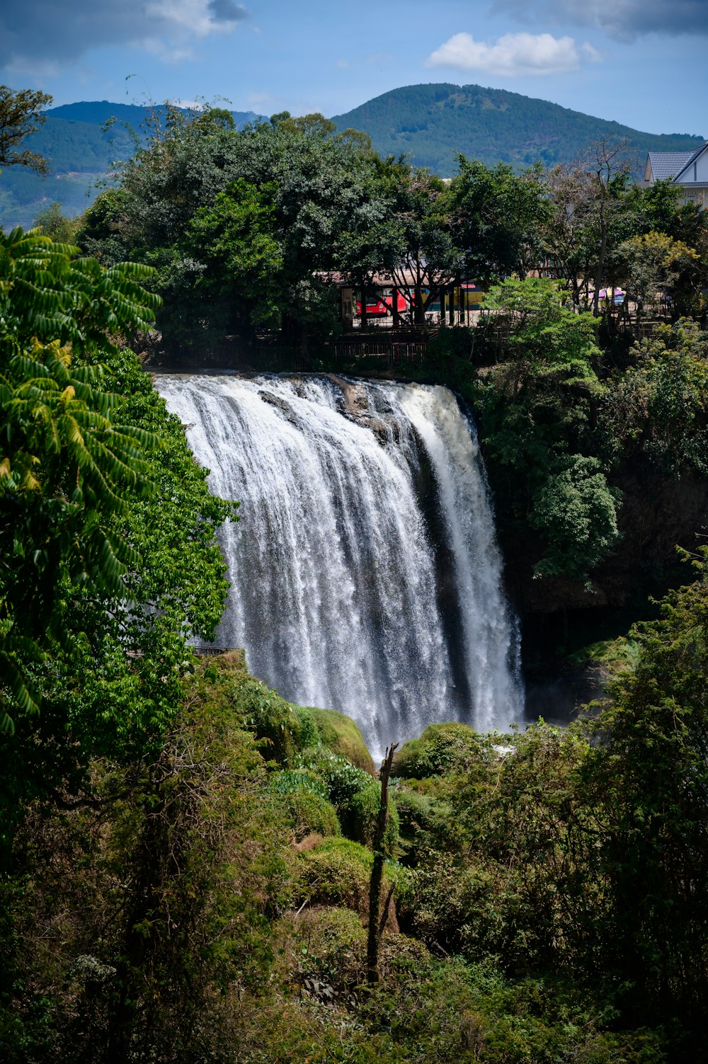 a large waterfall with a bridge over it