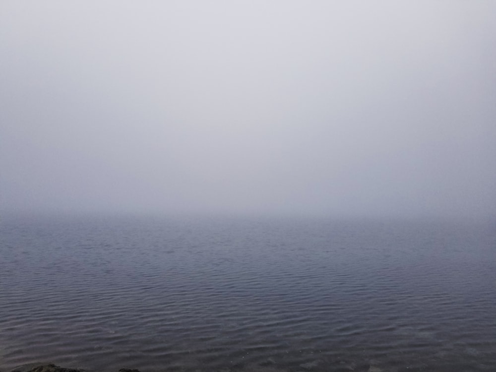 a large body of water sitting under a cloudy sky