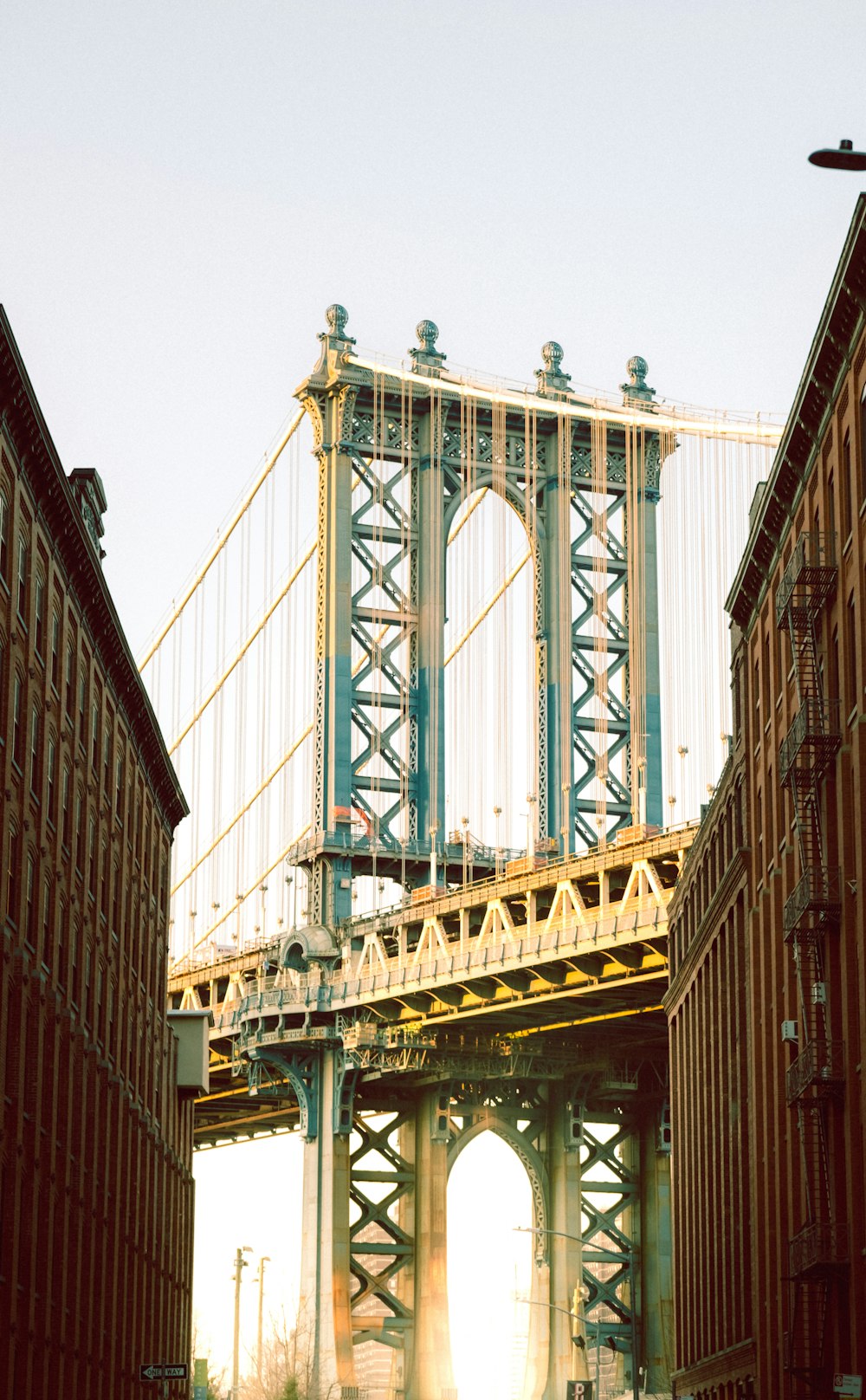 a large bridge spanning over a river next to tall buildings