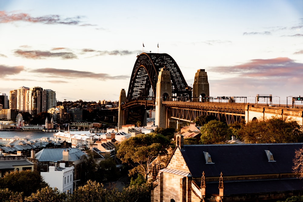 a large bridge spanning over a city with tall buildings