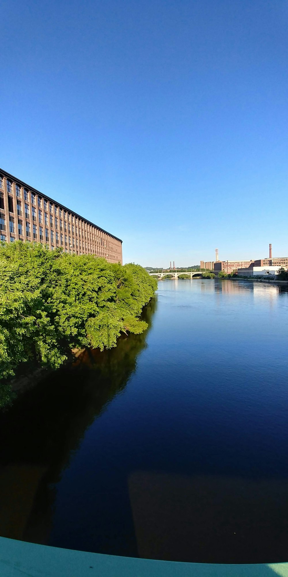 a body of water with a bridge in the background