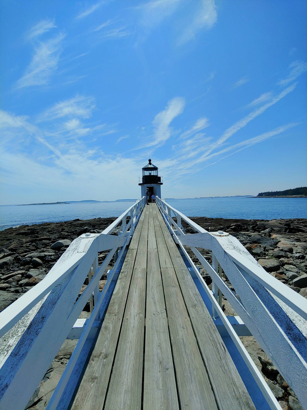 a wooden pier with a light house on top of it