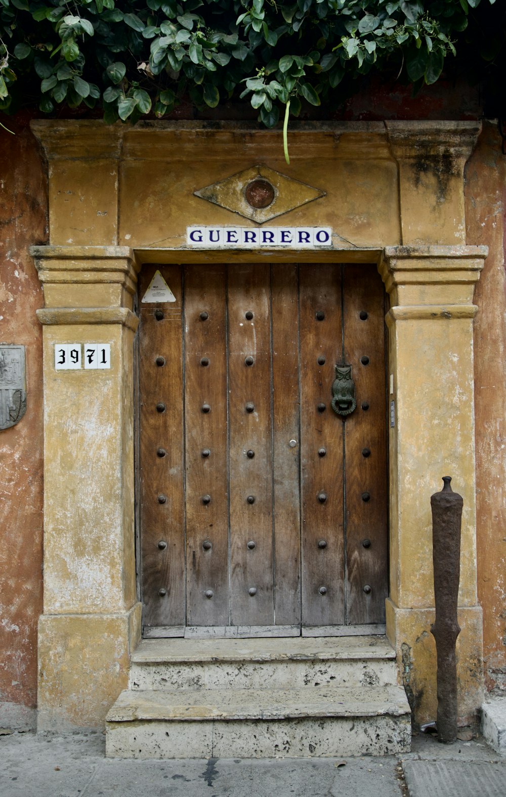 a wooden door with a sign above it