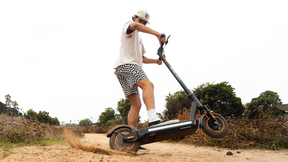 a man riding an electric scooter on a dirt road
