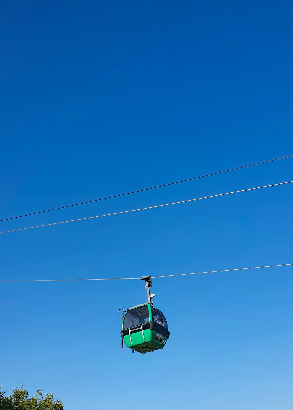 a person riding a ski lift on a clear day