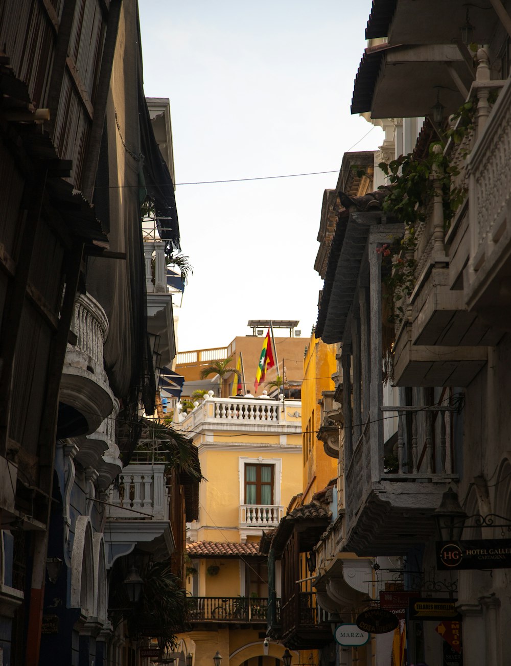 a narrow city street with buildings on both sides