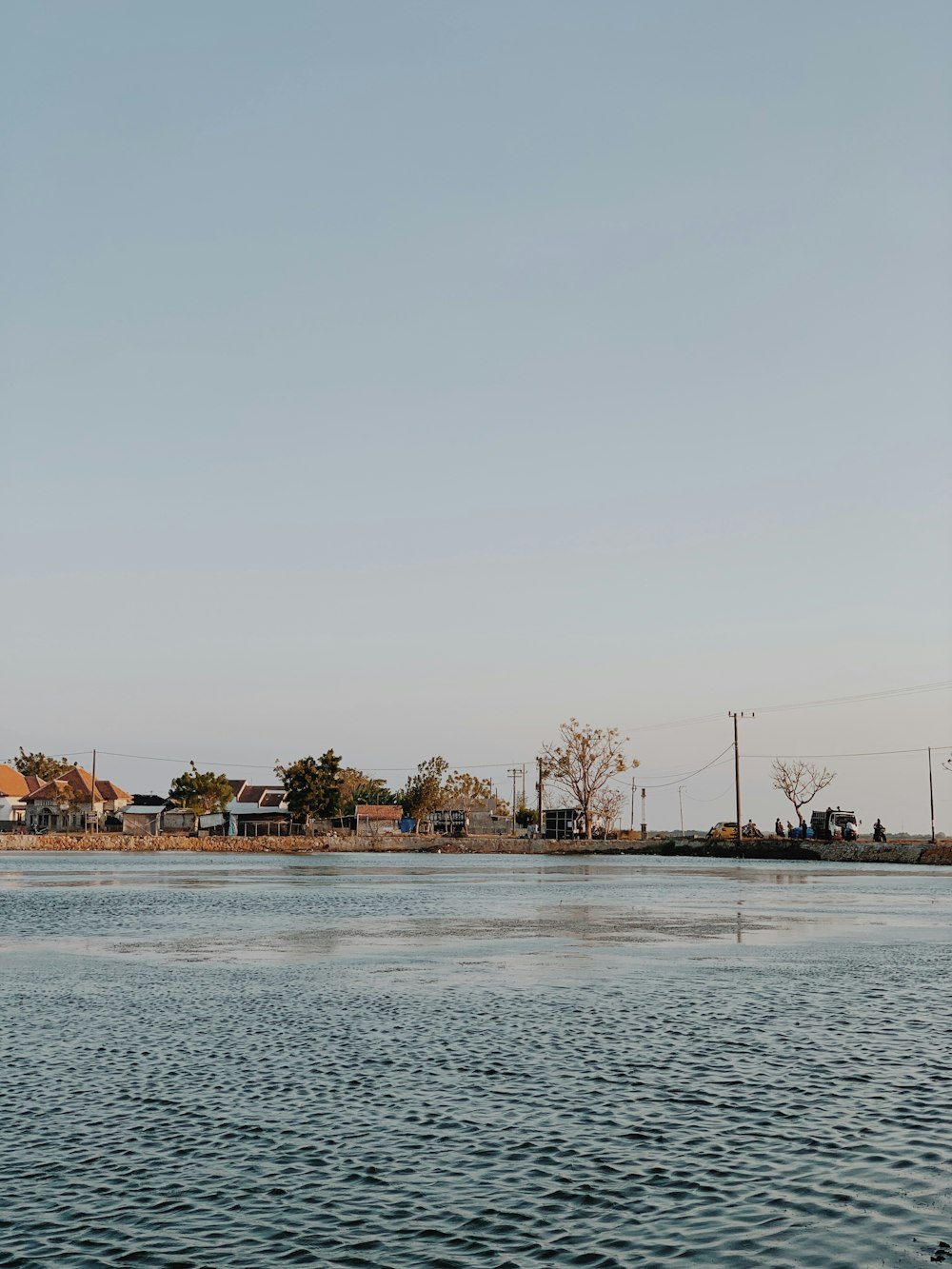 a body of water with houses in the background