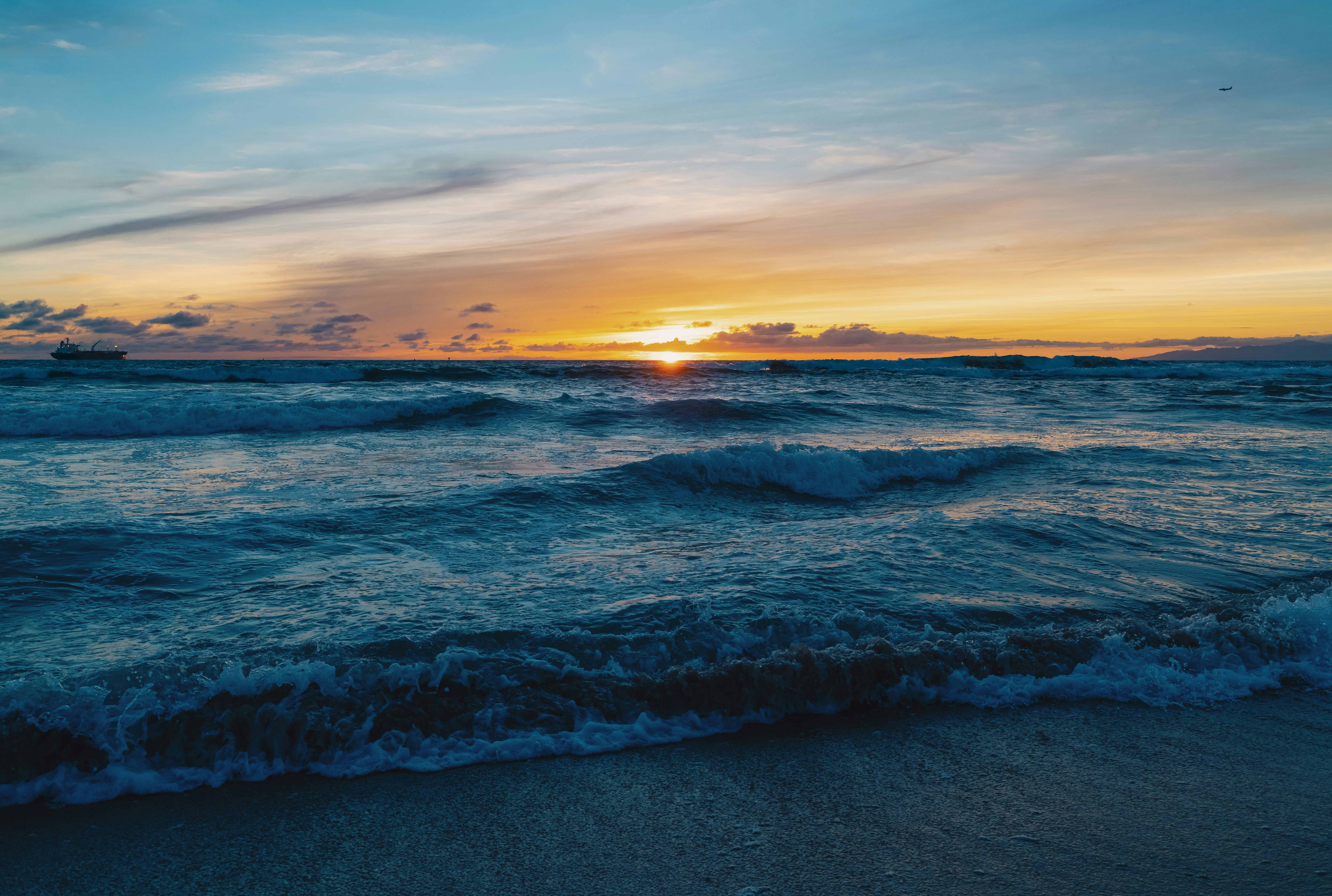 Sun setting over the ocean waves