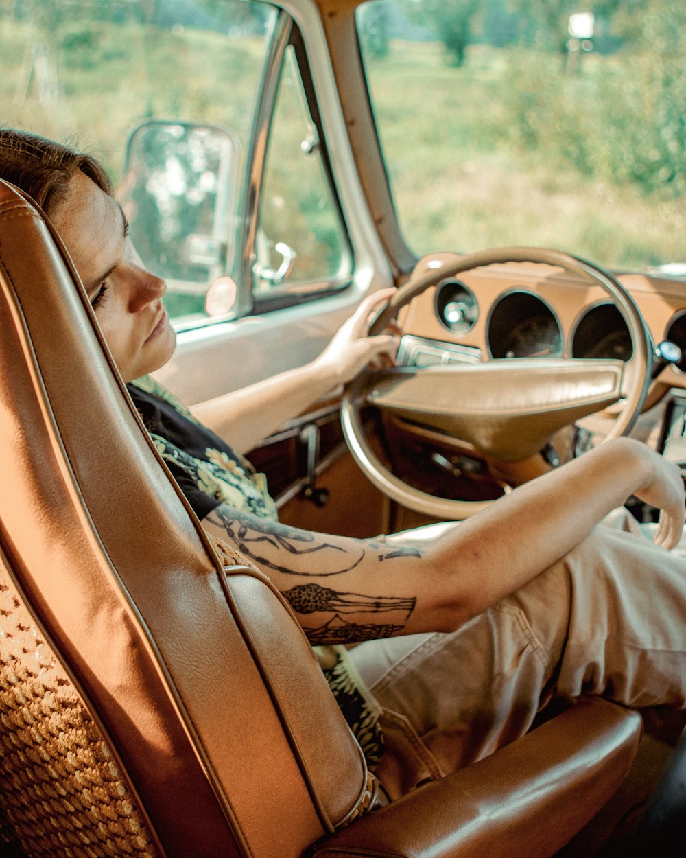 a woman sitting in the driver's seat of a car